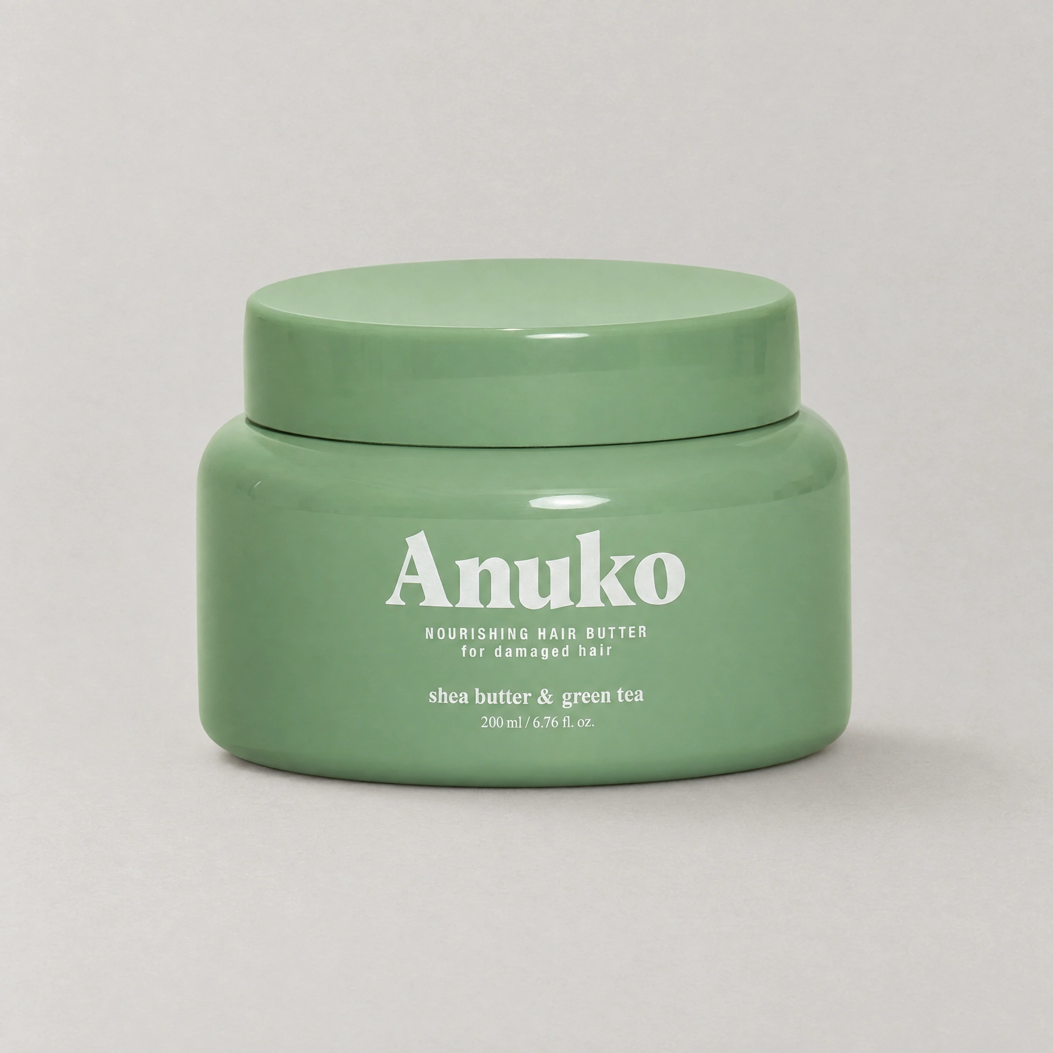 Anuko Nourishing Hair Butter, open sage-green jar of whipped cream
