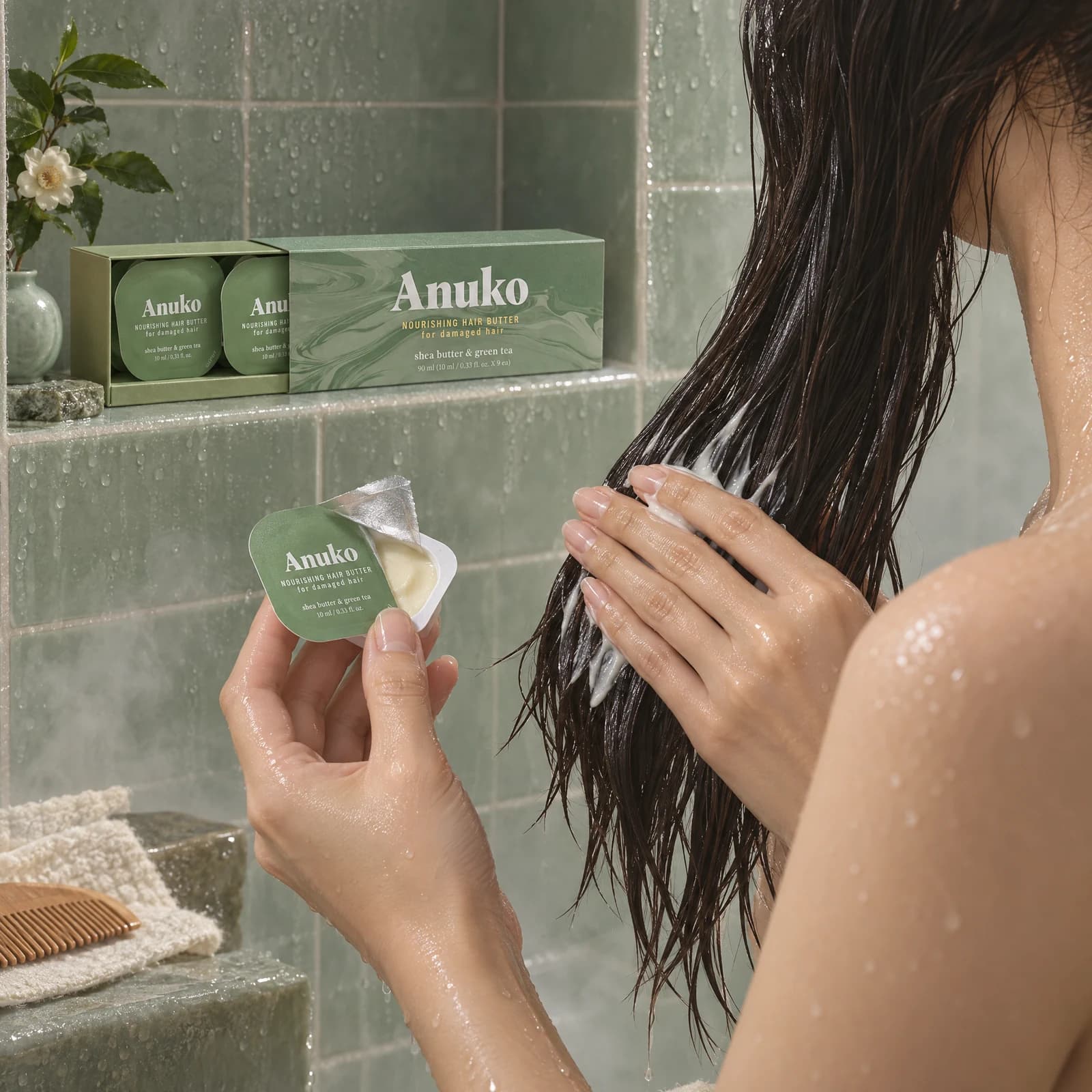 Model applying Travel Hair Butter through wet lengths in the shower